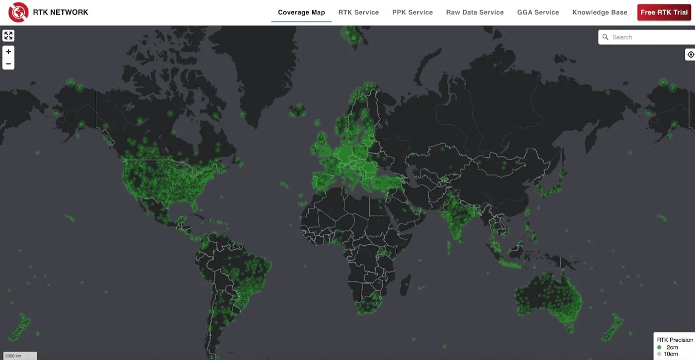 Screenshot of the GEODNET RTK Network coverage map, showing green station markers densely clustered across the United States, Europe, India and Australia, with thinner coverage in South America, Africa and Asia.