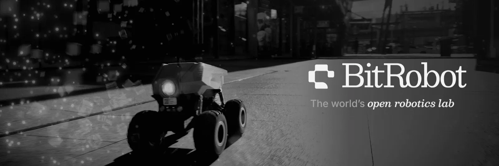 BitRobot banner: a six-wheeled sidewalk rover drives along a city pavement beside the BitRobot logo and the tagline The world's open robotics lab.
